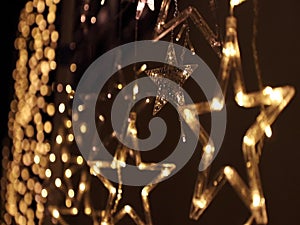 Christmas lighting decoration with bright LED lights in the shape of a gold star sparkles glitter.