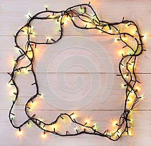 Christmas lights background. Holiday glowing garland on light wo