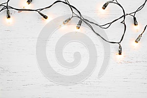 Christmas lights bulb decoration on white wood.
