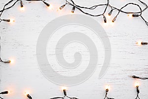 Christmas lights bulb frame decoration on white wood