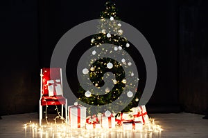 Christmas lights with Christmas tree and gifts on a black background