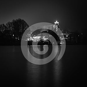 Christmas lights of a church reflected in a lake  in the dark