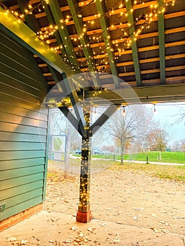 Christmas lights decorating a post and roof space