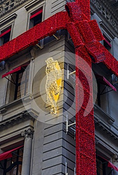 Christmas lights decorations of red ribbon and panther on the Cartier store on Fifth Avenue in Manhattan New York, USA