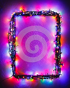 Christmas lights frame on snow background, purple color