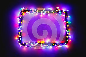 Christmas lights frame on snow background, purple color