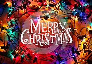 Christmas lights frame on wood background with Merry Christmas