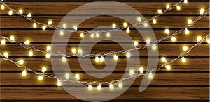 Christmas lights isolated on dark wooden background. Glow garland. Vector glow xmas light bulbs on wires.