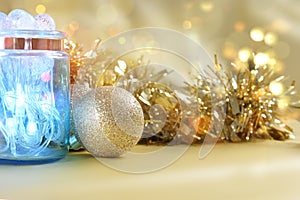 Christmas lights in jar on gold bokeh lights background