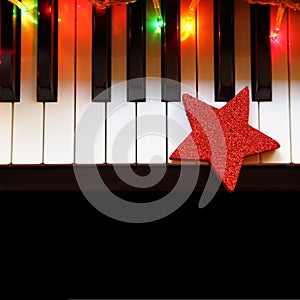 Christmas lights and ornament on piano