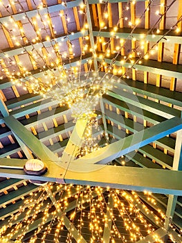 Christmas lights on the rafters of a building