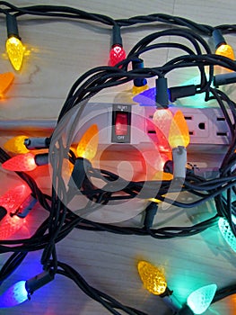 Christmas lights and red reset button on a socket-splitter