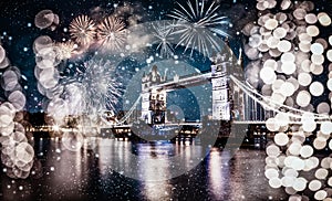 christmas lights and snow in London Tower bridge at night