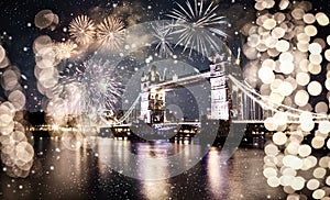 christmas lights and snow in London Tower bridge at night