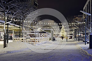 Christmas lights and christmas tree in the snowy town photo