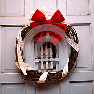 Christmas lights and wreath on front door at night