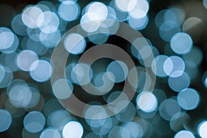 Christmas lights. Xmas. Festive New Year blurred blue and black background. Sparkling backdrop, texture. Bokeh.