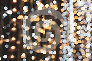 Christmas lights. Xmas. Festive New Year blurred golden, silver and black background. Sparkling backdrop, texture. Bokeh
