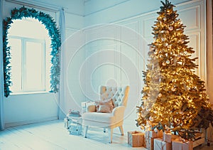 Christmas living room with a Christmas, gifts tree and bed. Beautiful New Year decorated classic home interior. Winter background