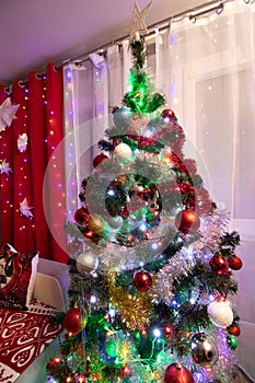 Christmas living room with a colorful decorated Christmas tree