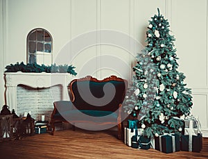 Christmas living room with a fireplace, sofa, Christmas tree and gifts. Beautiful New Year decorated classic home interior. Winter