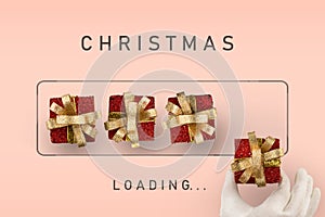 Christmas loading - boxes with gifts are laid out by Santa Claus hand. Waiting for the new year holiday concept. Pink background