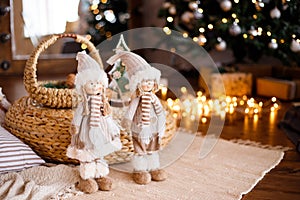 Christmas loft room interior with figures, the New year 2019 decorated with light gifts toys, candles, holiday concept