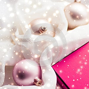 Christmas magic holiday background, festive baubles, pink vintage gift box and golden glitter as winter season present for luxury