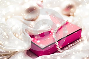 Christmas magic holiday background, festive baubles, pink vintage gift box and golden glitter as winter season present for luxury