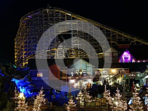 Wooden roller coaster scenery by night in holiday season