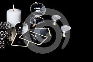 Christmas magical sessions with tarot cards, candle, ring and mirror at night in dark room. Mysterious Christmastide fortune