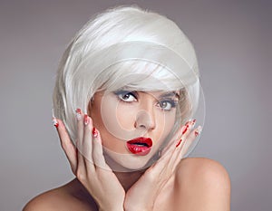 Christmas makeup and manicure nails. Surprised woman face posrtrait. blonde girl with short bob white hair style and red lips