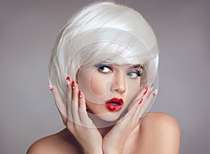 Christmas makeup and manicure nails. Surprised woman face posrtrait. blonde girl with short bob white hair style and red lips