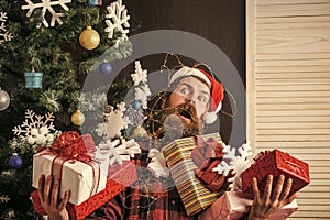 Christmas man with beard on scared face hold gift.