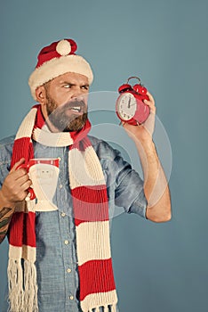 Christmas man look alarm clock and cup