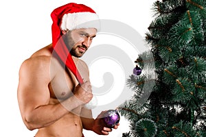 Christmas man standing near the fir-tree isolated on a white background.