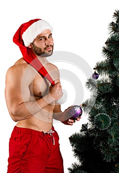 Christmas man standing near the fir-tree isolated on a white background.