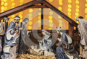 Christmas nativity scene with figurines in lights