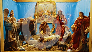 Christmas Manger scene with figurines including Jesus, Mary, Joseph, sheep and magi. Nativity scene with hand-colored figures made