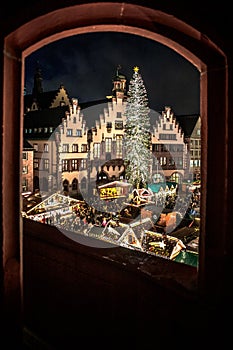 Christmas market in the city of Frankfurt am Main, Christmas lights in the evening carousel half-timbered houses and town hall