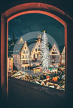 Christmas market in the city of Frankfurt am Main, Christmas lights in the evening carousel half-timbered houses and town hall