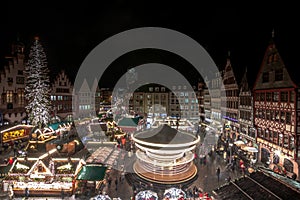 Christmas market in the city of Frankfurt am Main, Christmas lights in the evening carousel half-timbered houses and town hall