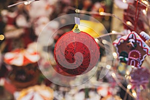 Christmas market details with New Year decorations and multicolored flags, garlands and festoons, Xmas atmosphere, fair interior,