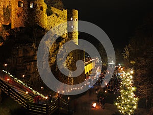 Christmas market at medieval castle by night historic event