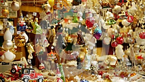 Christmas market stall or stand with tree decorated ornaments products star, toys, balls, garlands, various, fish