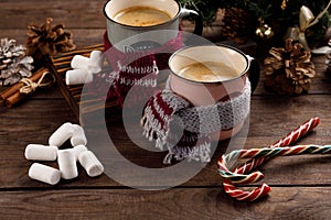 Christmas marshmallows and New Year decorations and sweet canes on a wooden background. Winter holidays, new year mood. Copy space