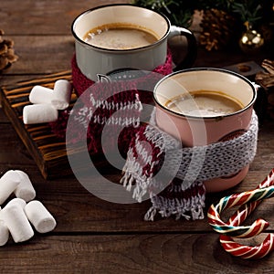 Christmas marshmallows and New Year decorations and sweet canes on a wooden background. Winter holidays, new year mood. Copy space