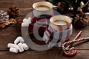 Christmas marshmallows and New Year decorations and sweet canes on a wooden background. Winter holidays, new year mood. Copy space