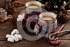 Christmas marshmallows and New Year decorations and sweet canes on a wooden background. Winter holidays, new year mood. Copy space