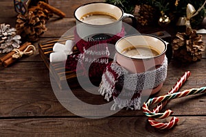 Christmas marshmallows and New Year decorations and sweet canes on a wooden background. Winter holidays, new year mood. Copy space